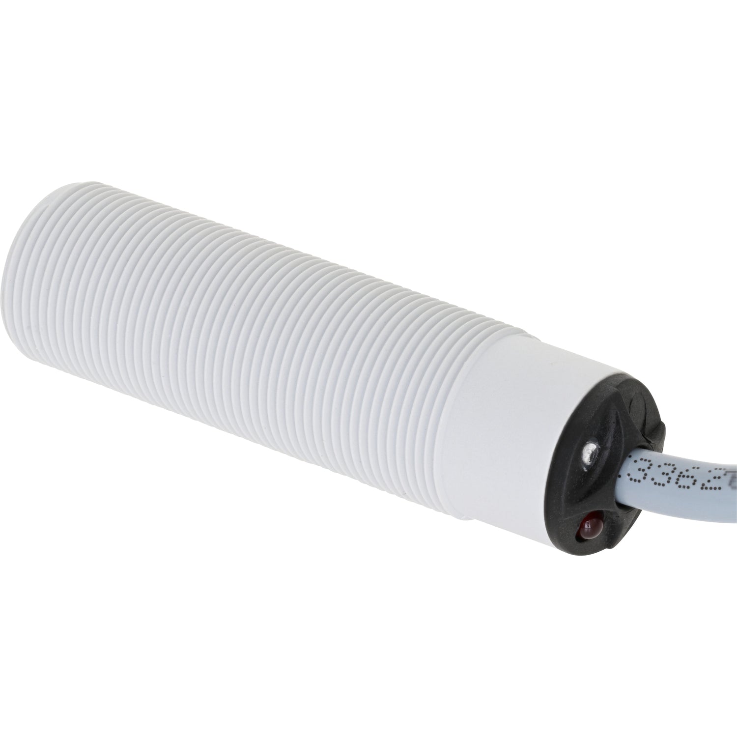White and black cylindrical threaded inductive sensor on white background.