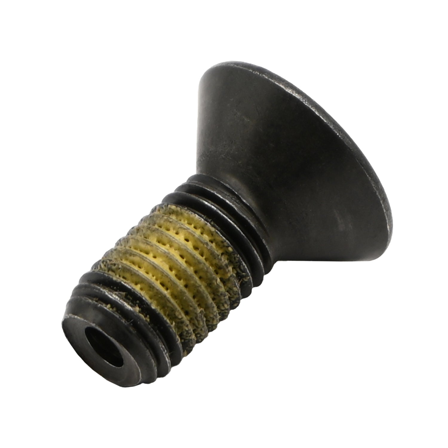 Black alloy steel flat head socket head cap screw with yellow nylon patch on white background. 