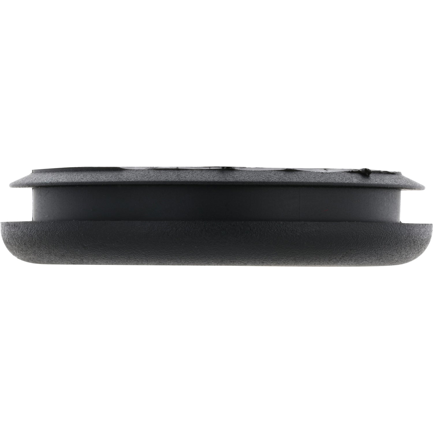 Low profile black plastic disk shaped plug on white background. 