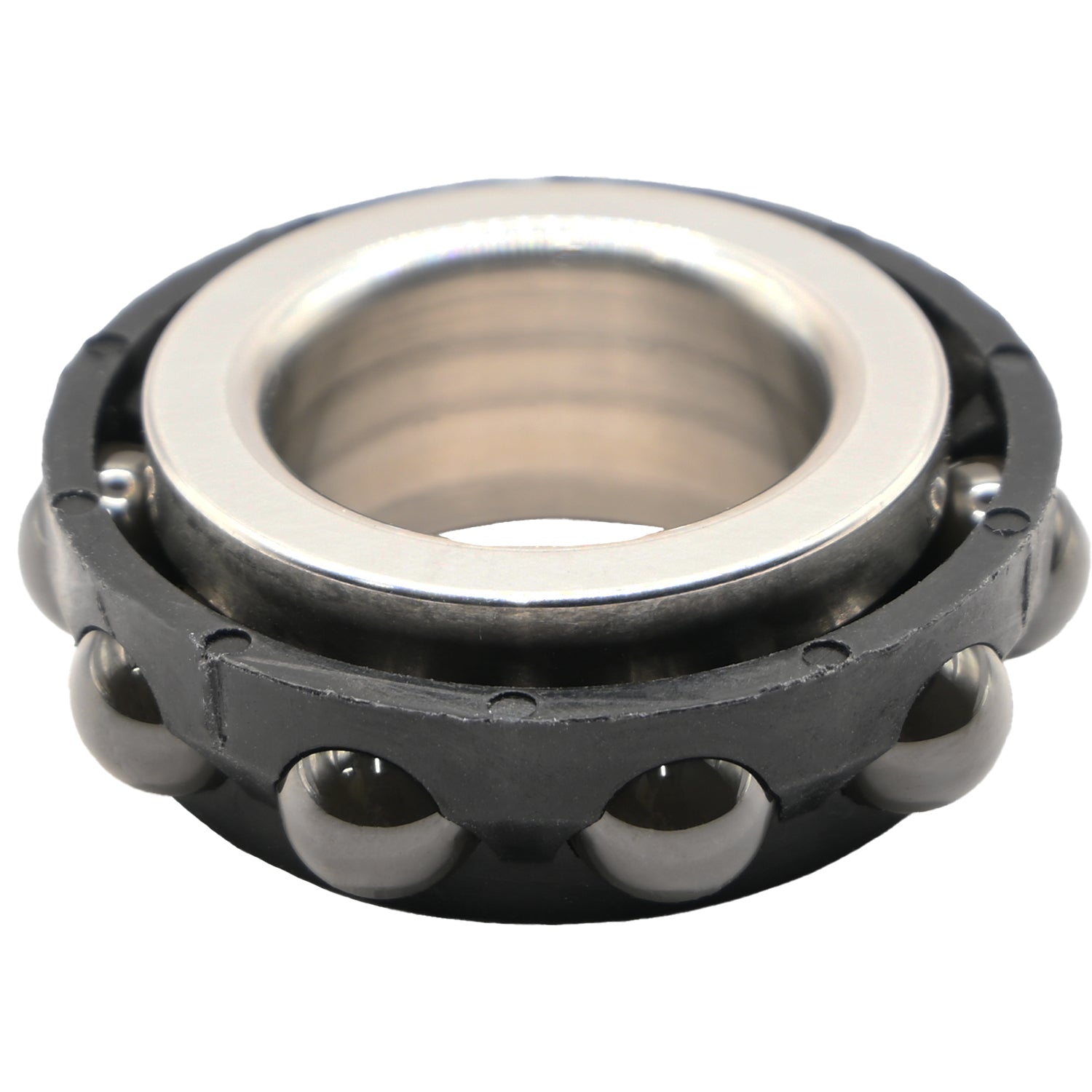 Black plastic ceramic ball bearing with stainless steel inner race on white background. 