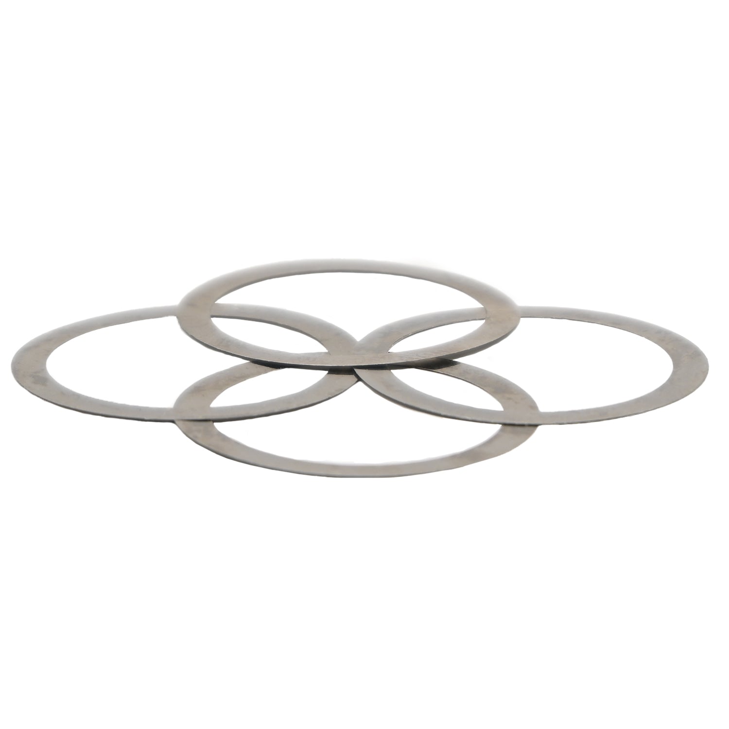 Four flat circular stainless steel shims stacked on one another on a white background. 