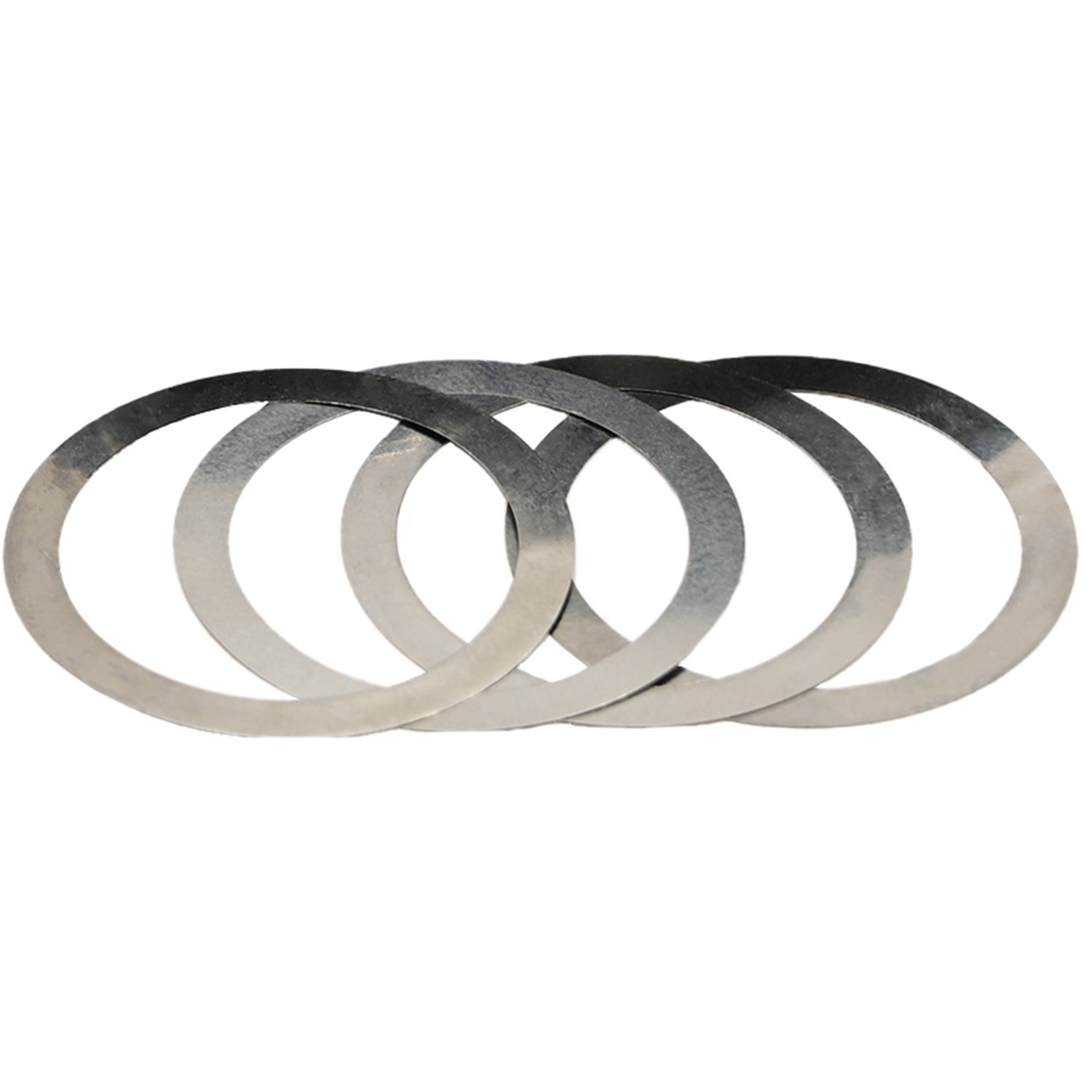 Four flat circular stainless steel shims stacked on one another on a white background. 