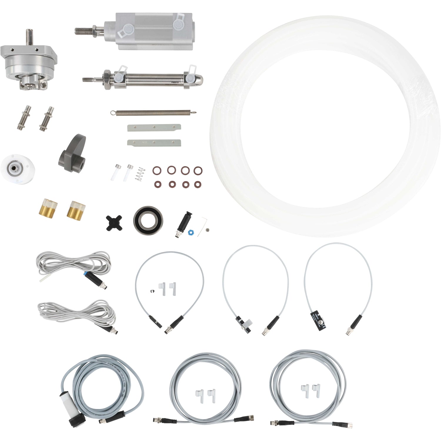 An assortment of parts that include pneumatic cylinders, sensor cables, o-rings, product tubing, springs, bearings and a rotary cam. Parts shown on a white background.